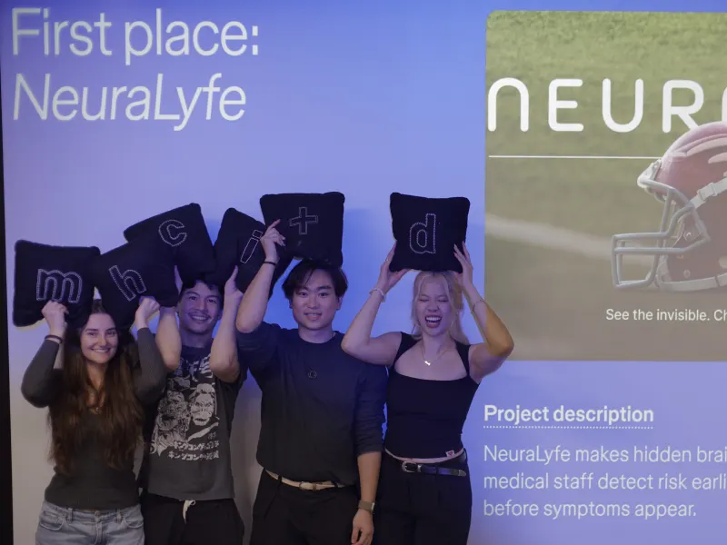 Naomi and her NeuraLyfe teammates in front of the first-place slide