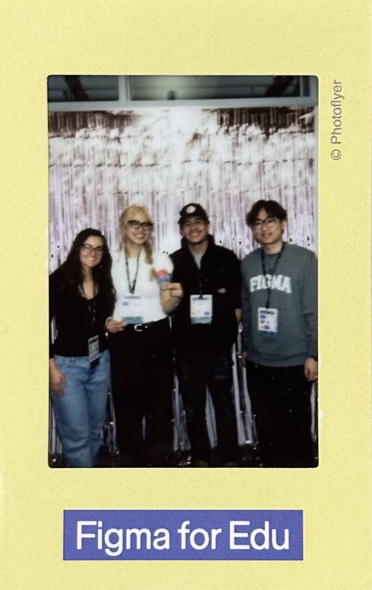 An instant photo of the four teammates at the event, wearing lanyards, in a yellow Figma for Edu frame.