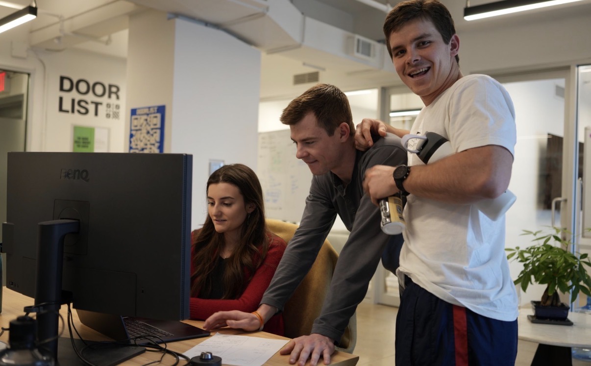 The DoorList team leaning over my screen at the office